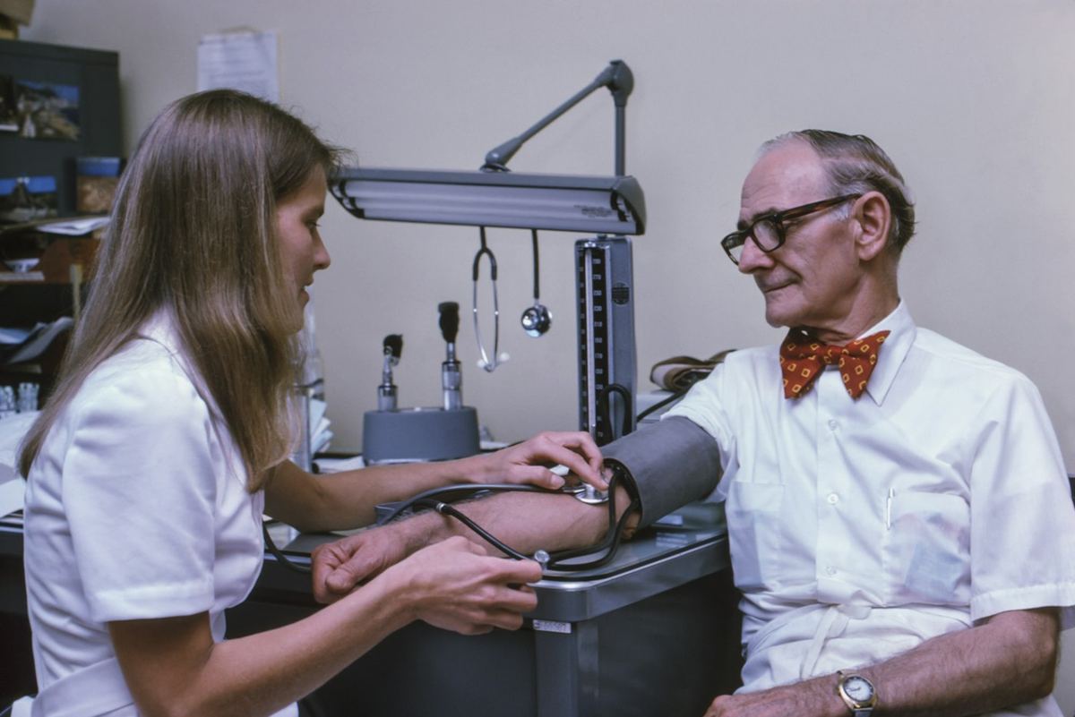 A doctor examining a patient’s ankle
